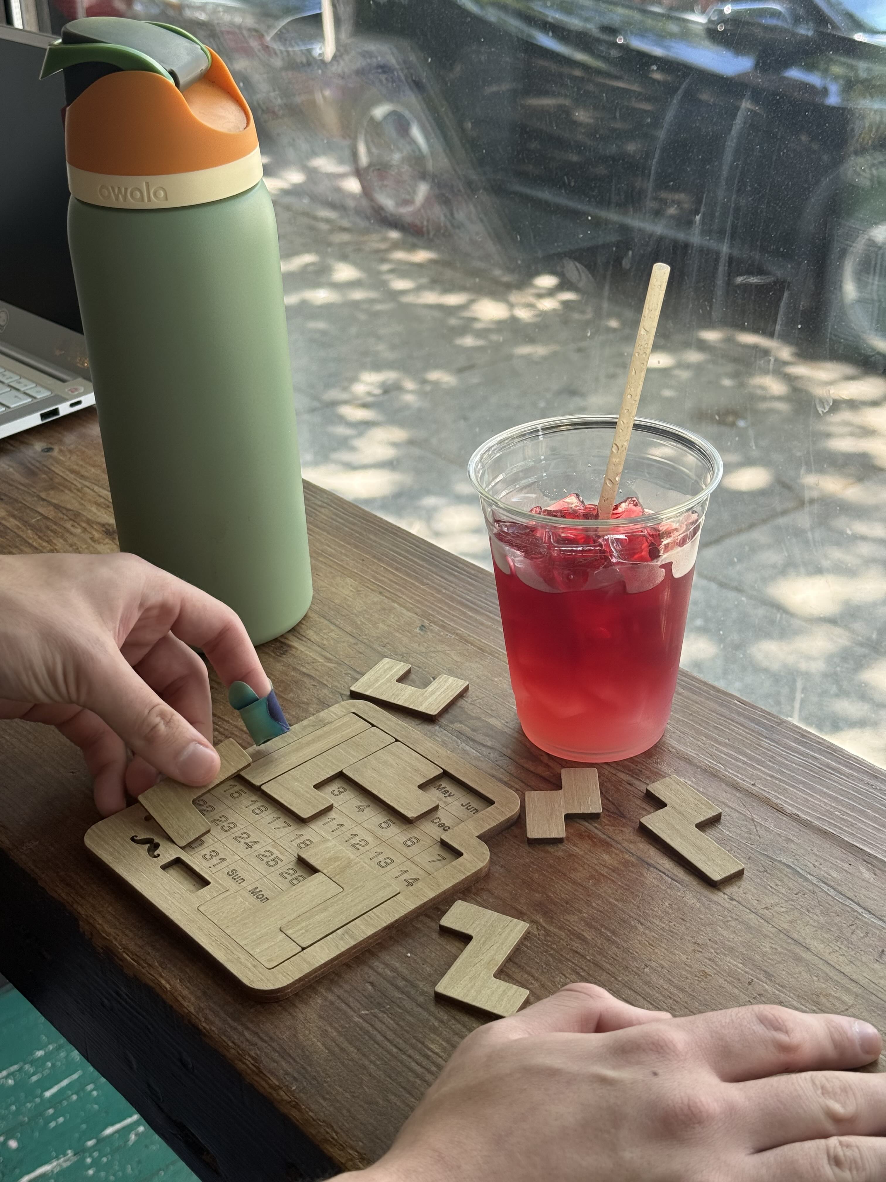 close up photo of a person's hands while playing the physical calendar puzzle