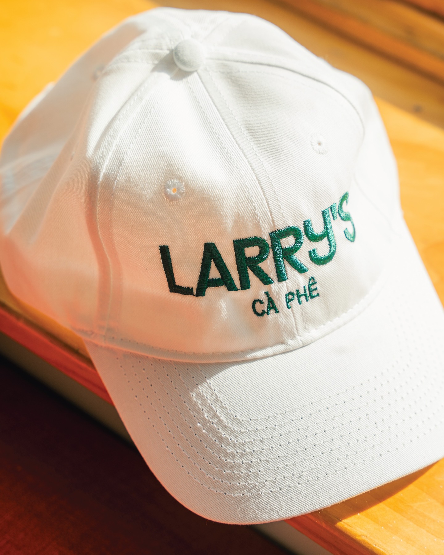 Larrys merch white and yellow hat front photo